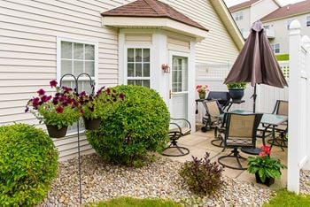 Private patio with dining area and flowers